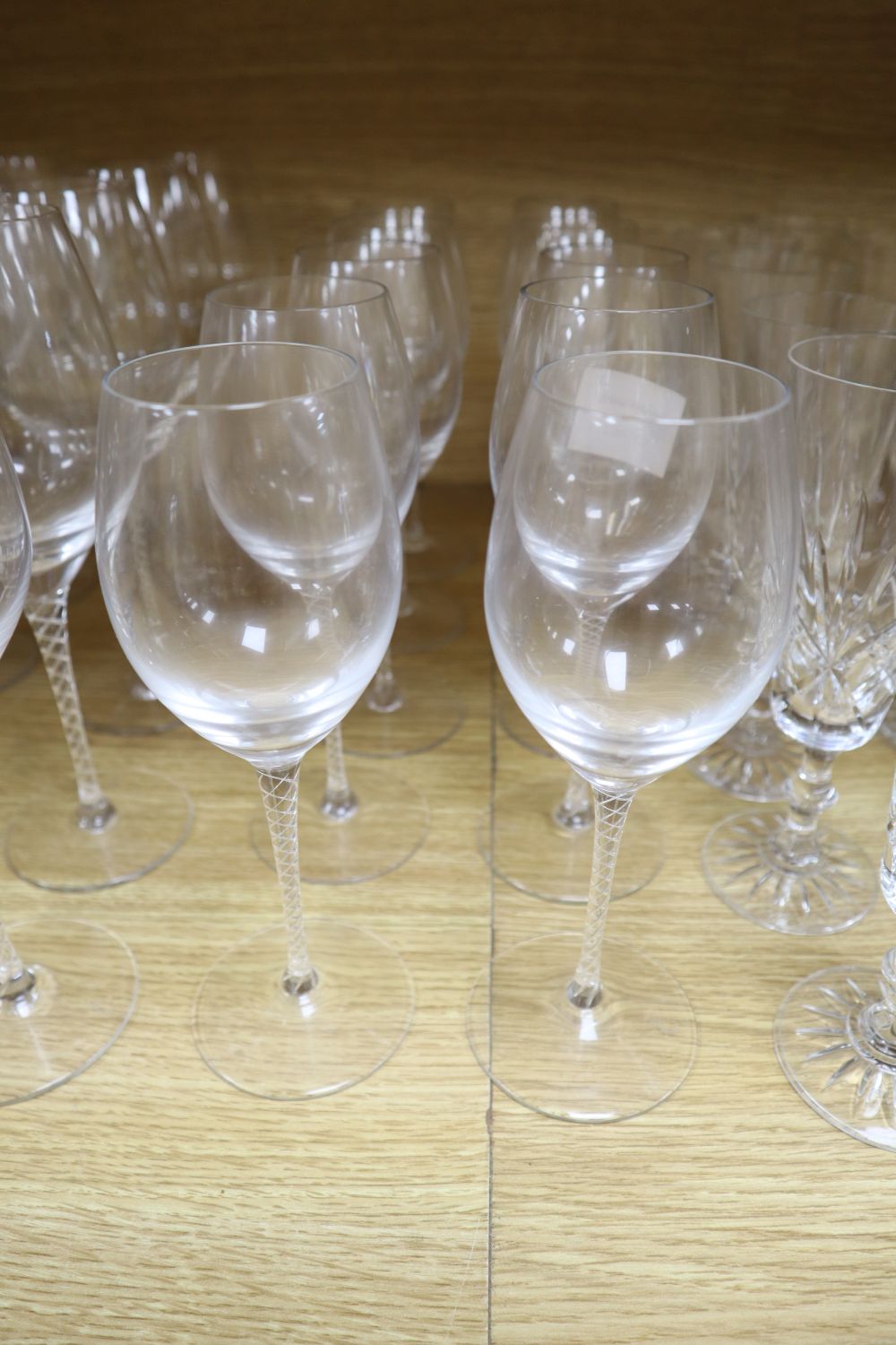 Twenty air twist stemmed wine glasses and eleven cut glass champagne flutes (31)